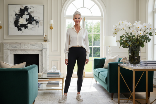  Elegant woman in her 50s standing tall and confident in a luxurious sunlit home, radiant and strong with a healthy vibrant appearance